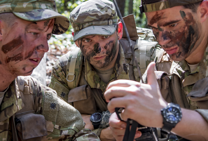group of soldiers looking at survival equipment